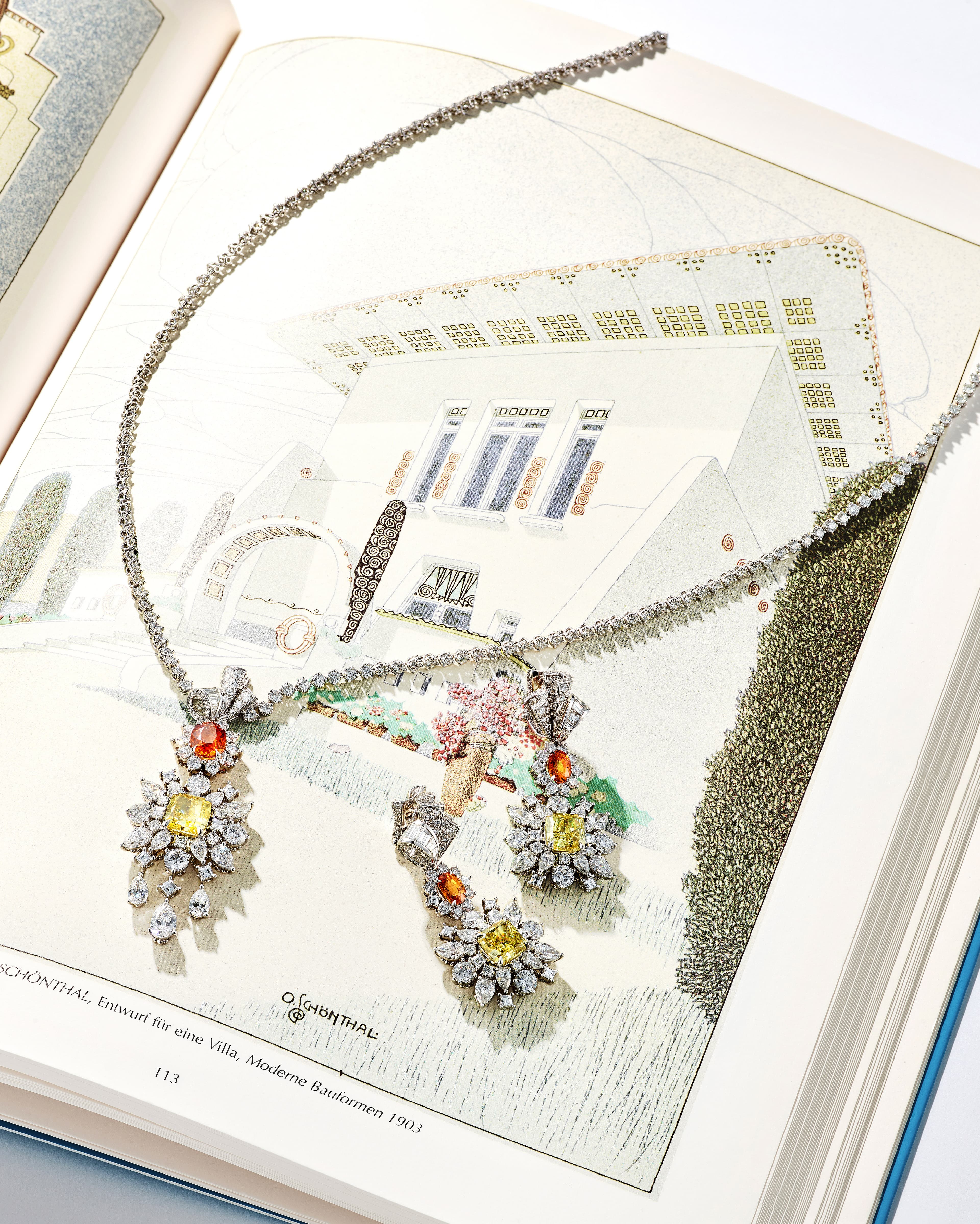 Jewelry resting on an open page of a vintage architecture reference book